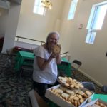 Lady with a large plate of big cookies.