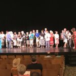 Several volunteers lined up on stage to be recognized.