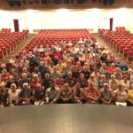 Group of volunteers sitting in theater.