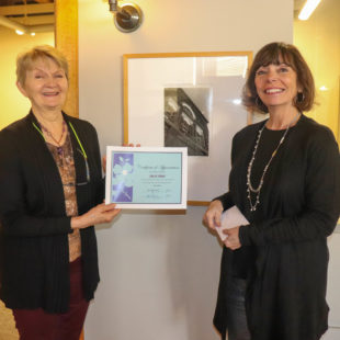sally ryan accepting certificate of appreciation